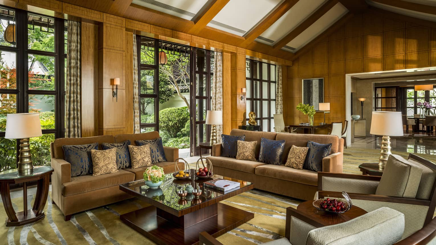Presidential Villa with two orange velvet sofas, chairs around modern wood table