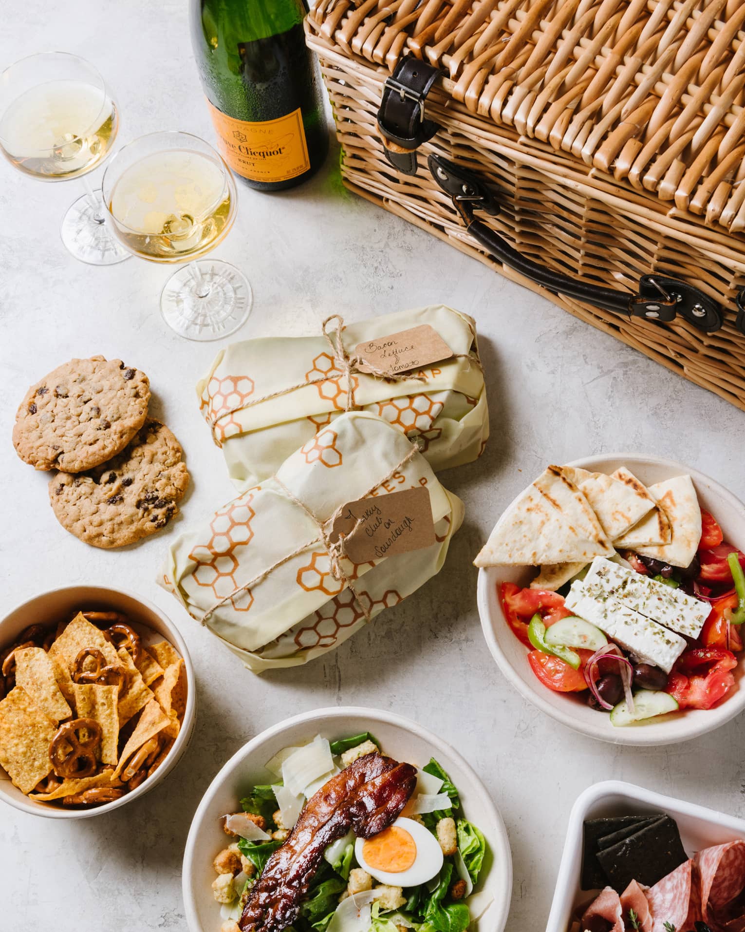 An assortment of food including salad, cookies and bread.