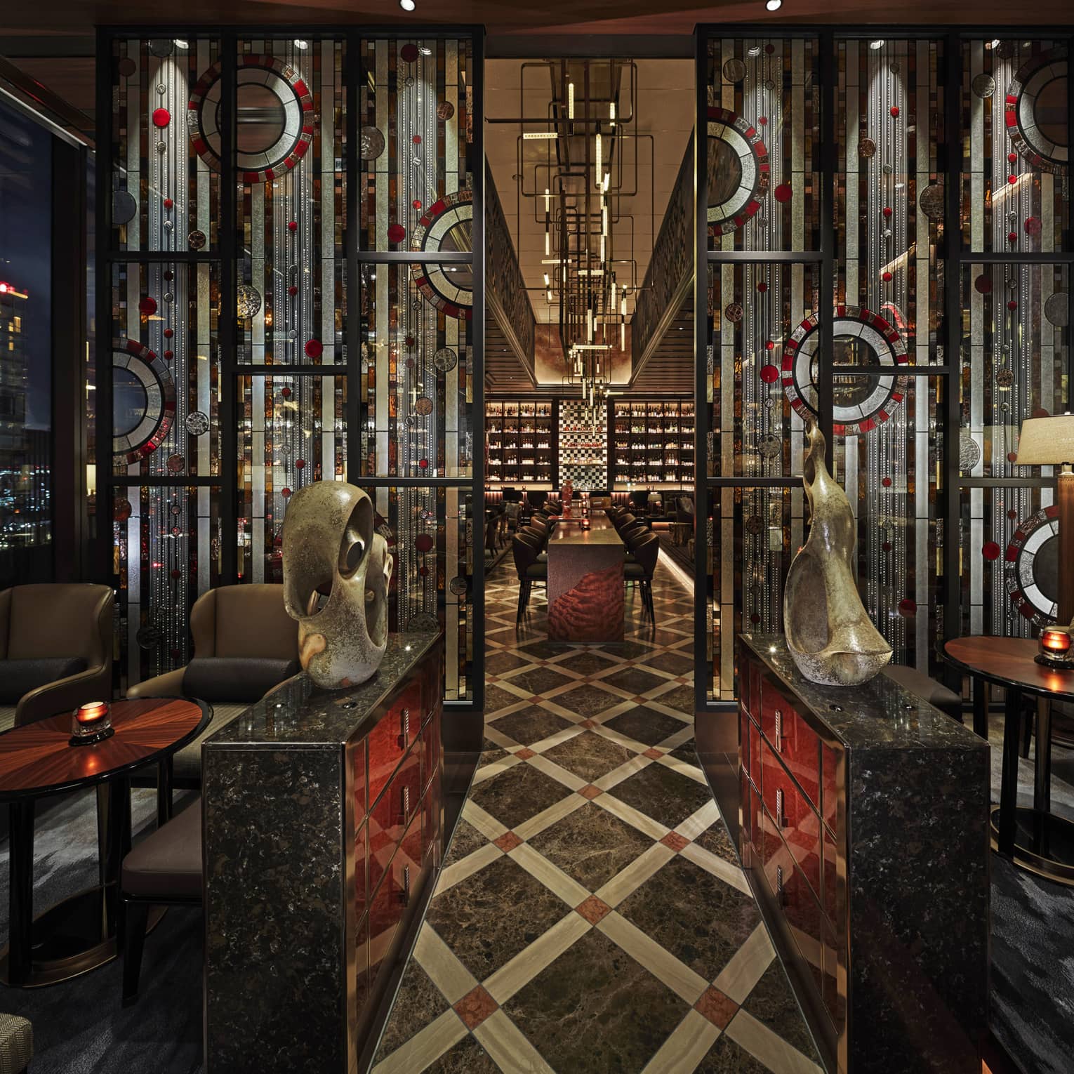 Entryway to VIRTU with sculptures, low lighting, red and black accents