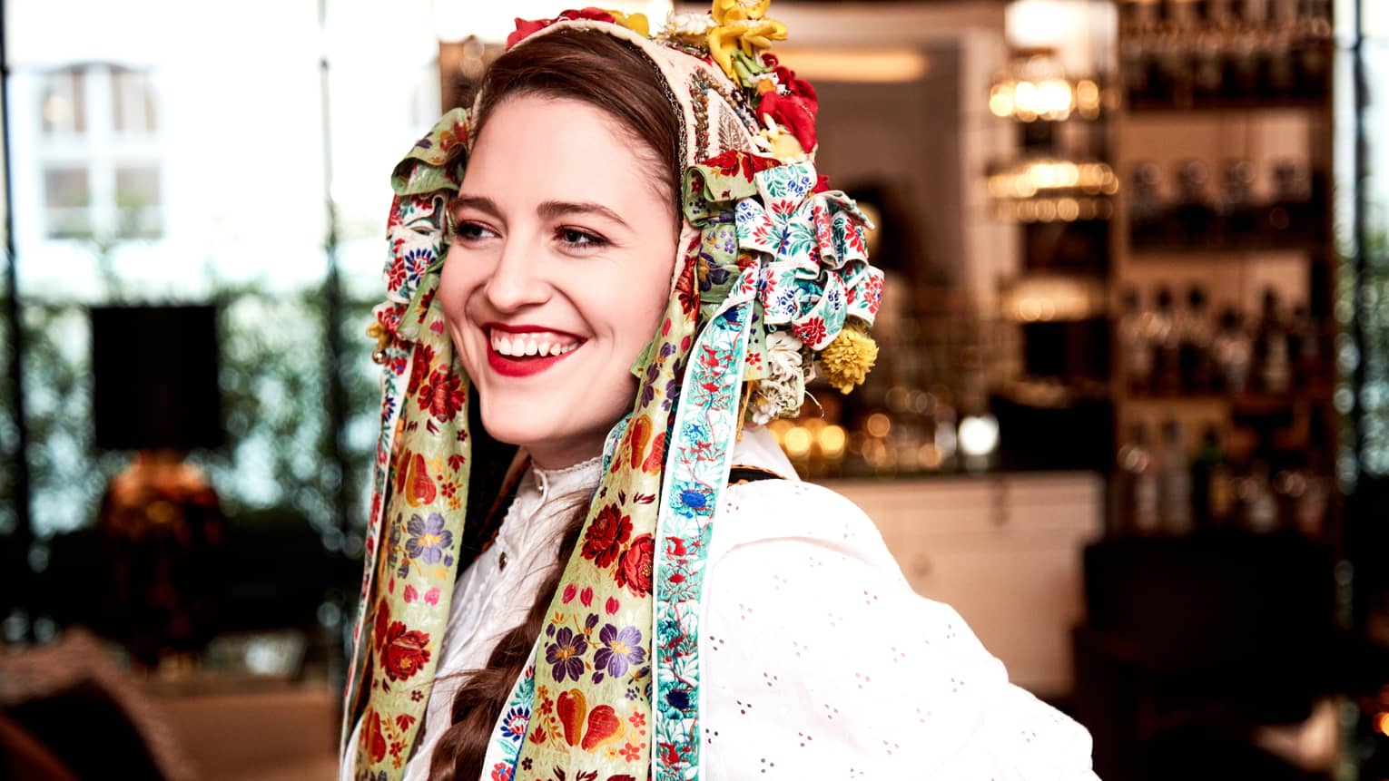 Smiling woman wearing colourful bows and ribbons in hair