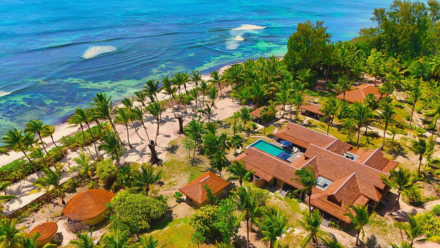 Aerial view of residence on tropical resort grounds near the ocean