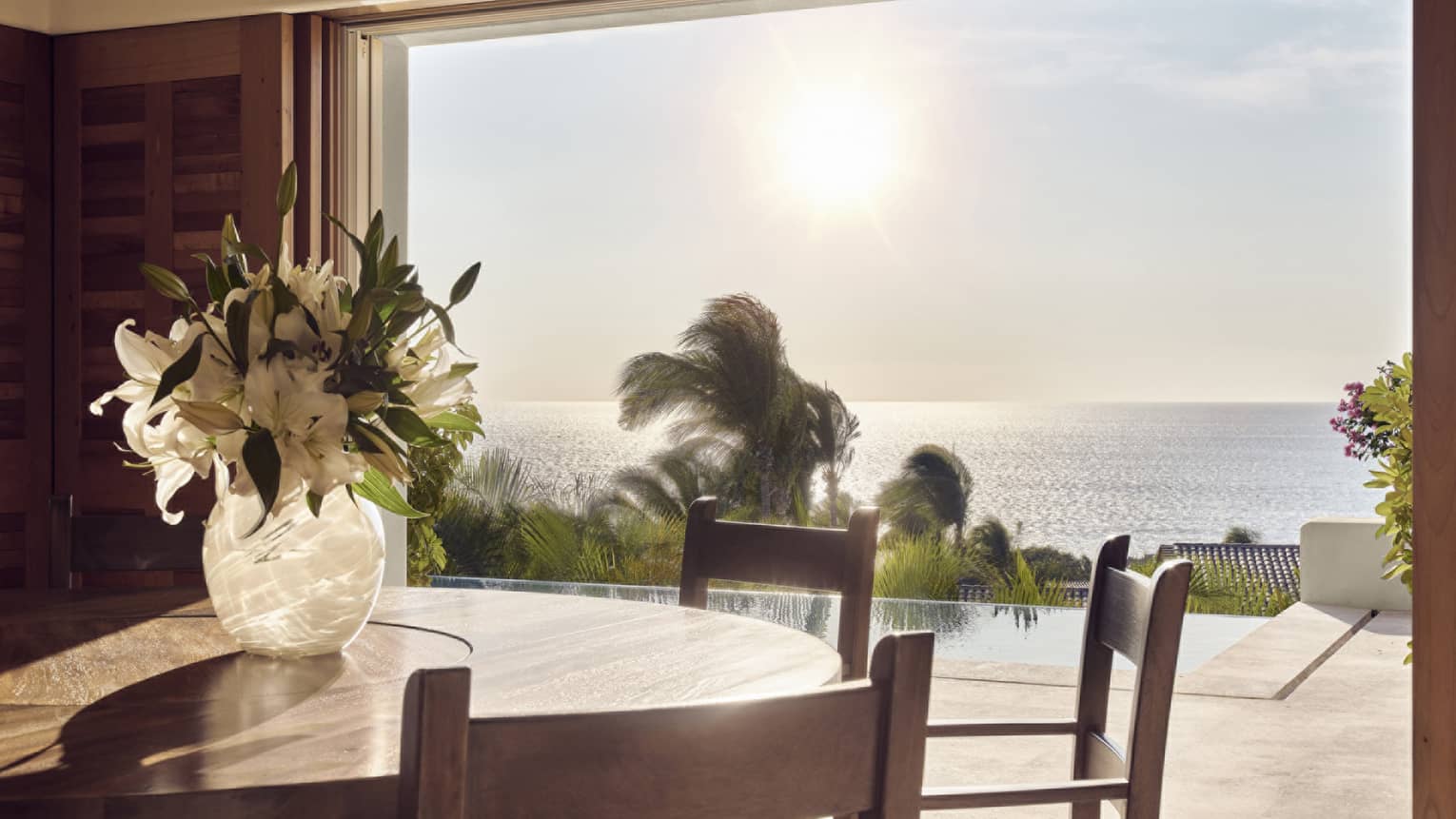 Dining room opening to private terrace with pool and ocean view