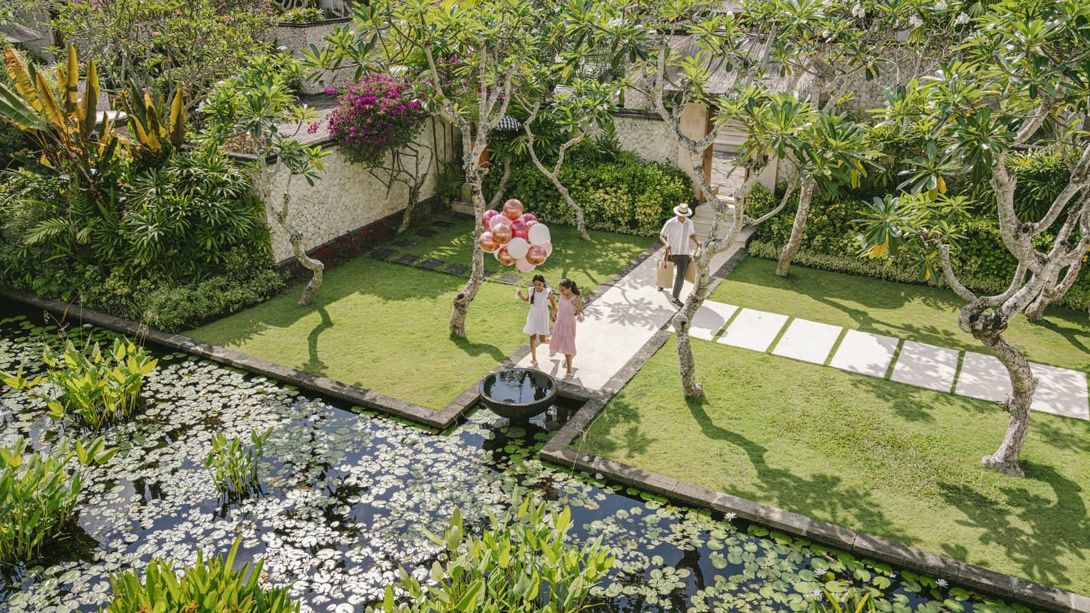 Aerial view of a residence entrance with lush foliage and greenery