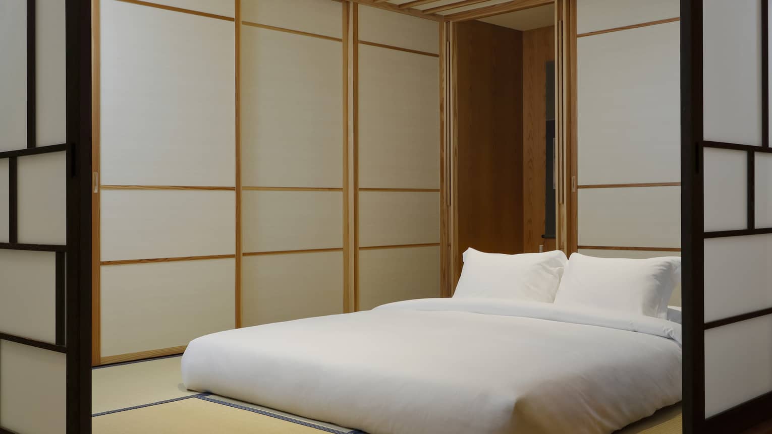 Tatami-style hotel room with king-sized futon and sliding doors