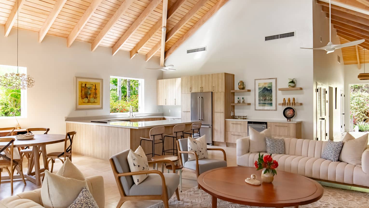A kitchen and living room area with wooden cabinets and ceiling