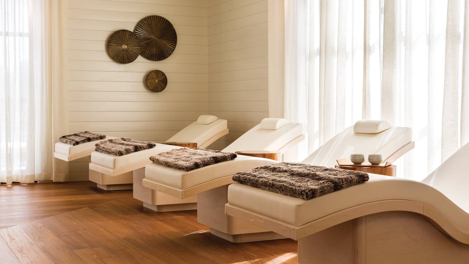 Spa chairs in a room with floor-to-ceiling windows