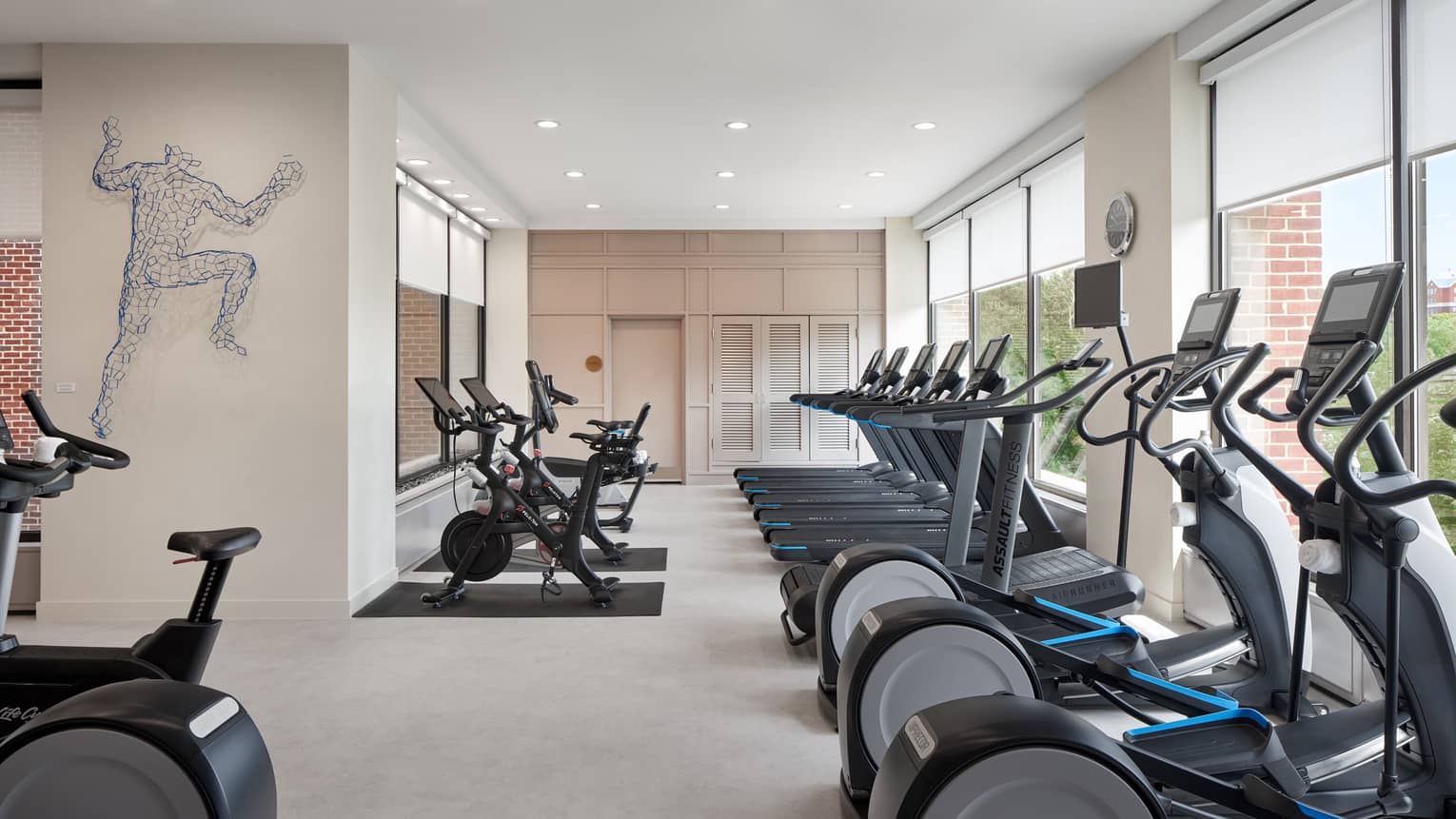Fitness centre with multiple treadmills, bicycles and ellipticals.