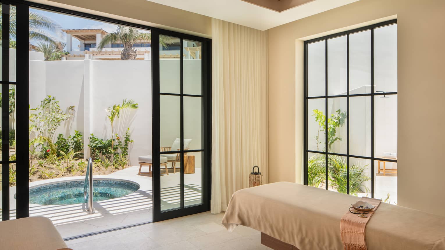 Luxury spa treatment room with access to private outdoor tub at Four Seasons Resort Cabo San Lucas at Cabo Del Sol