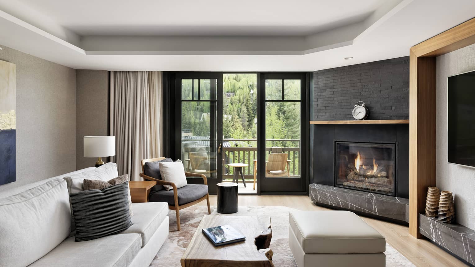 Living room with fireplace and walk-out balcony with mountain view