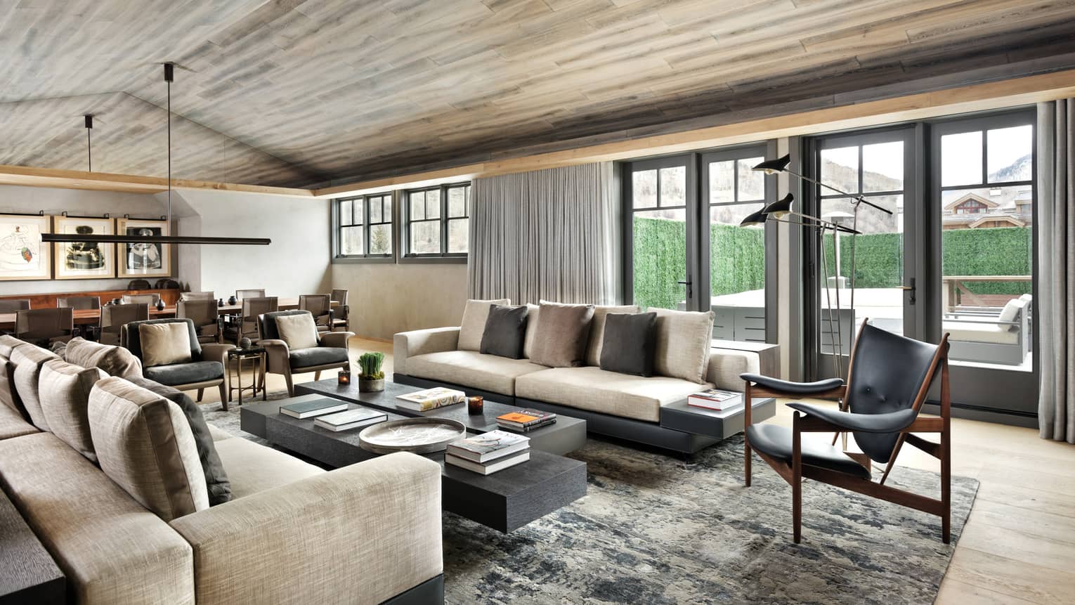 Long plush sofas, modern leather armchairs around large coffee table in bright living room