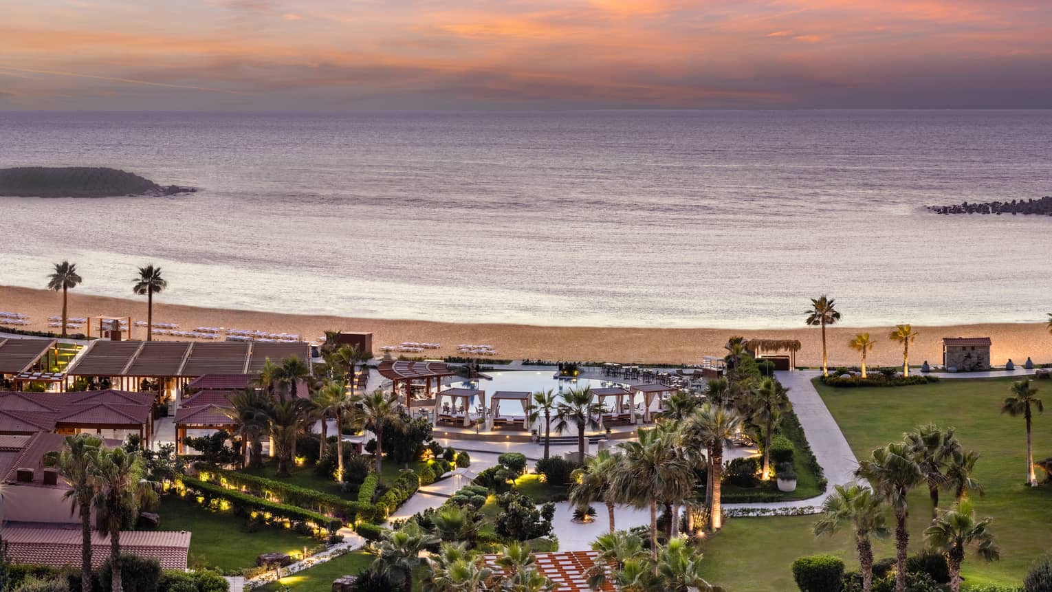 Aerial shot of pool and grounds leading to the beach from the Hotel