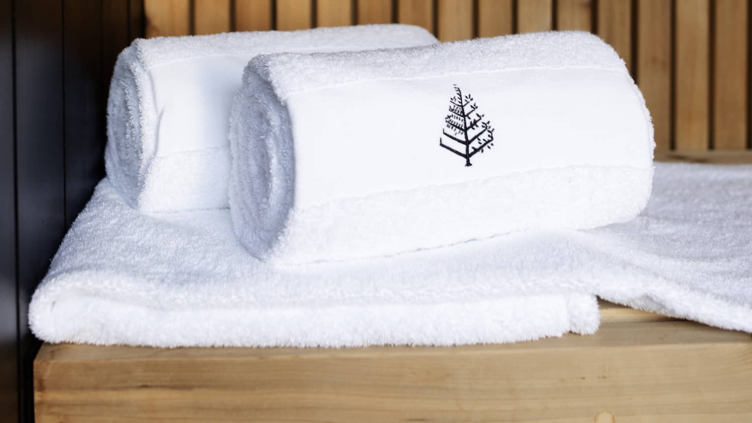 Towels rolled up with Four Seasons logo.
