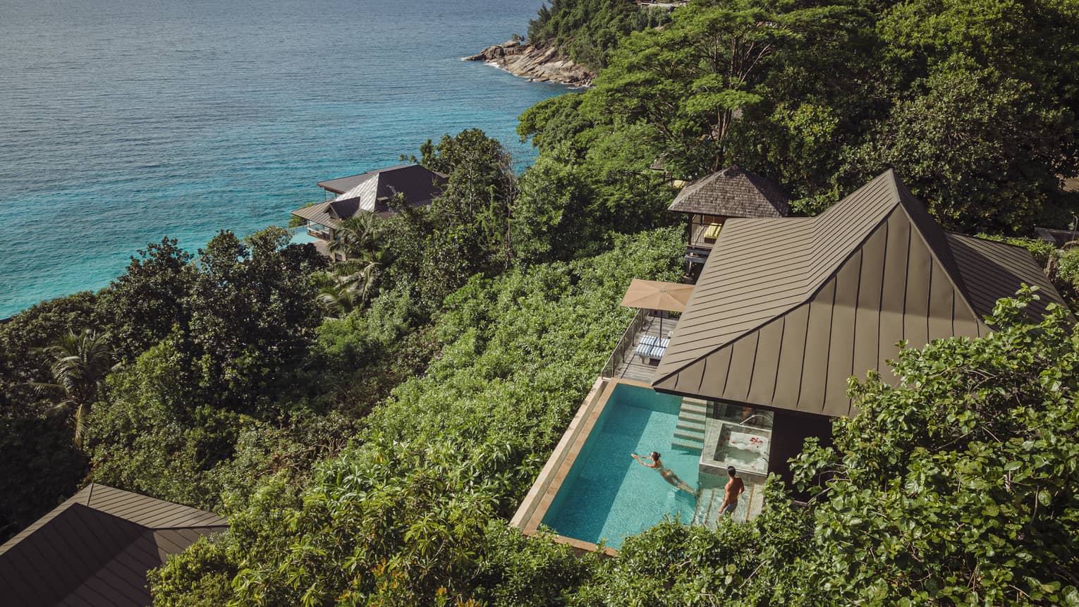 Aerial view of a Residence Villa at Four Seasons Resort Seychelles, overlooking turquoise ocean.