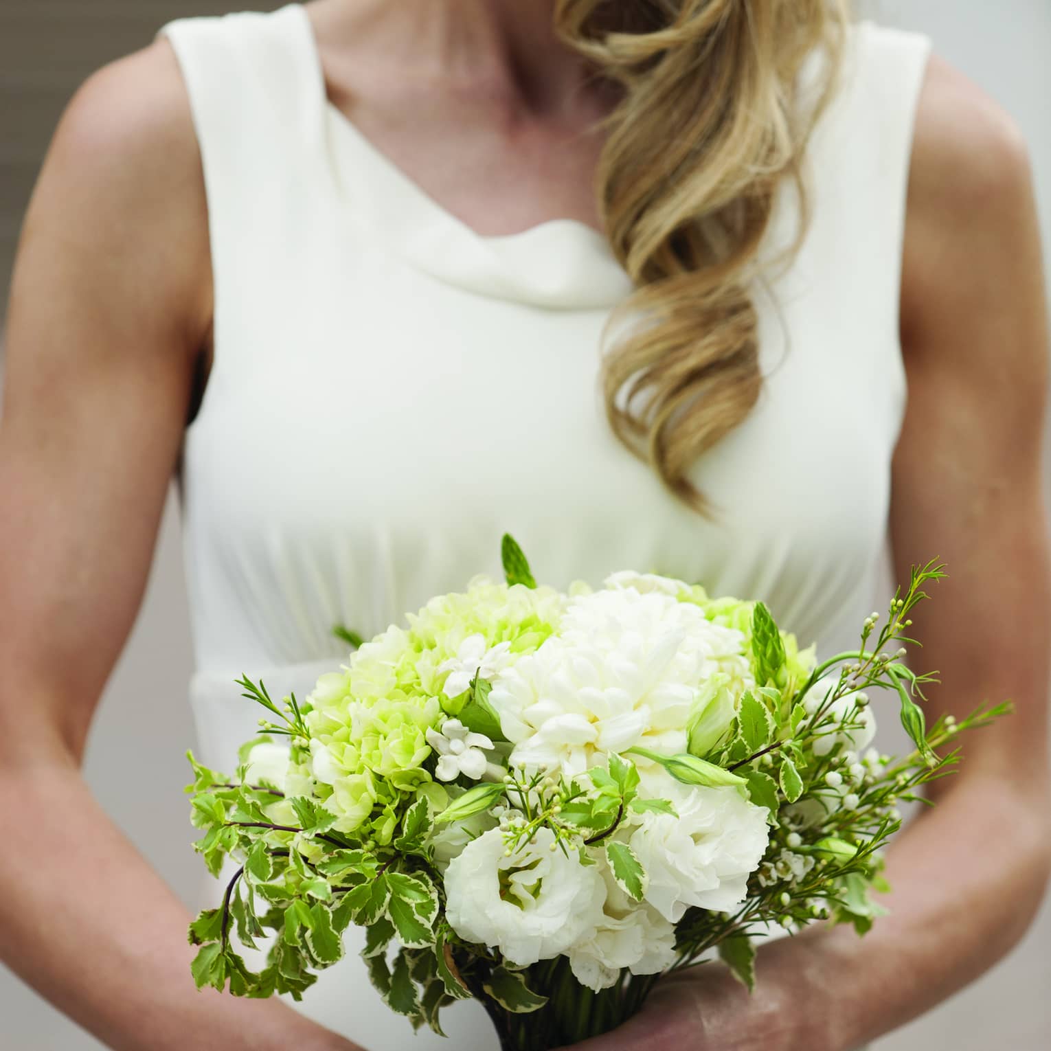Bride holding white floral wedding bouquet