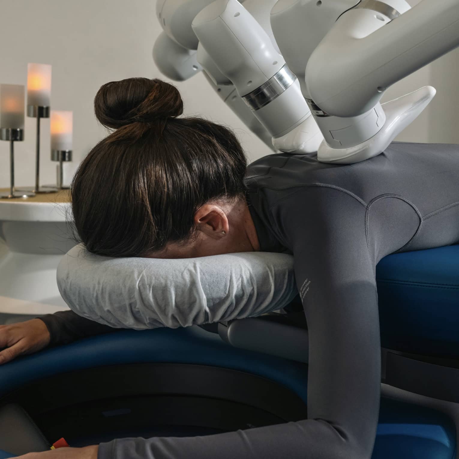 A guest laying on a massage table while getting a machined-powered massage