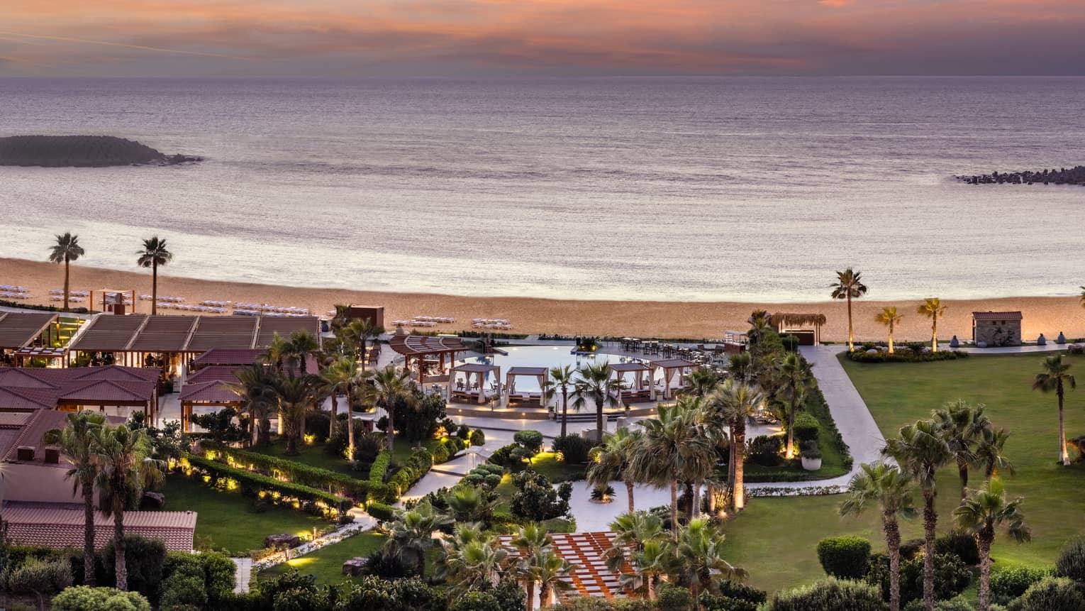 Aerial shot of pool and grounds leading to the beach from the Hotel