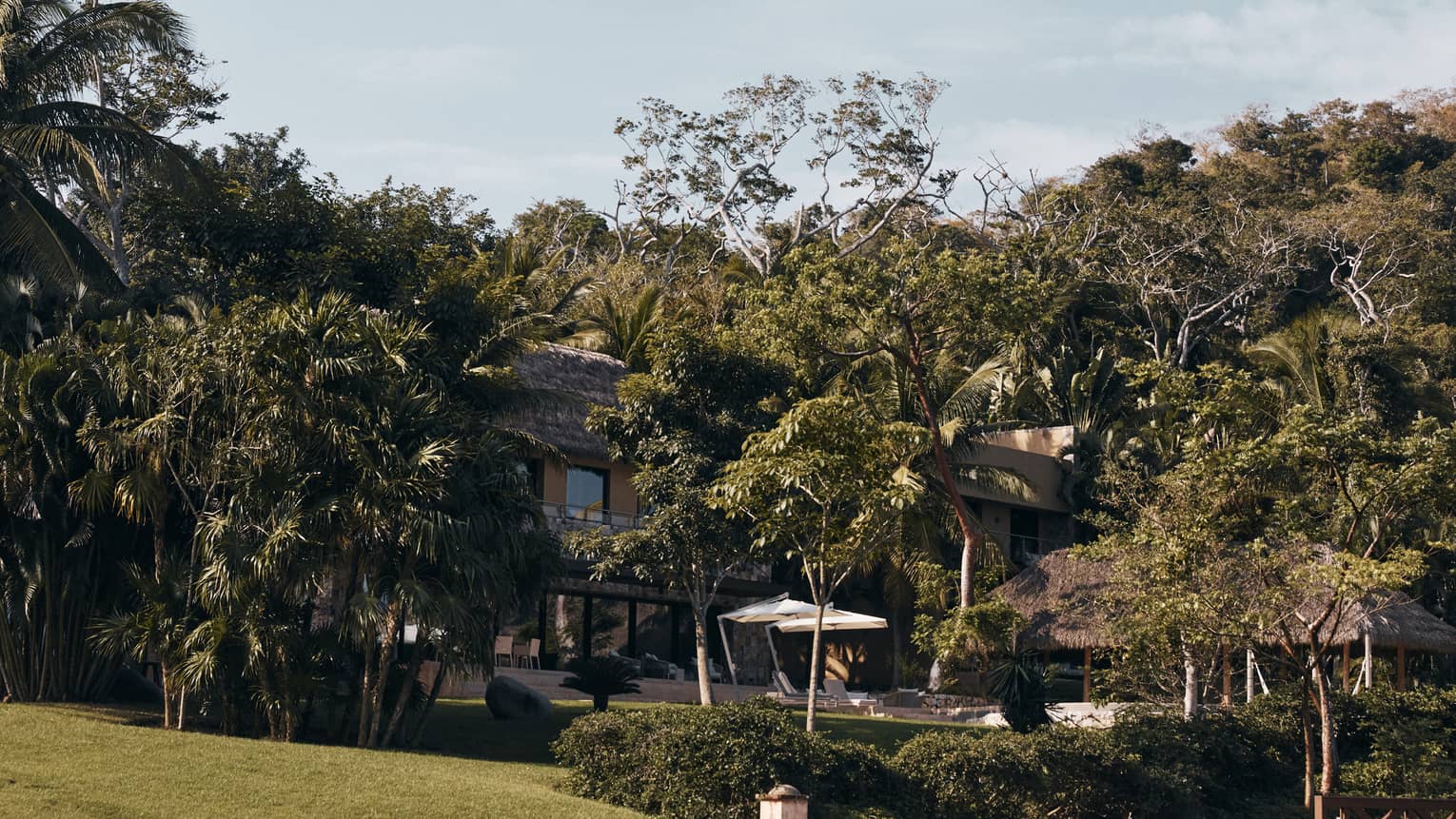 Exterior of Casa Vista six-bedroom residence at Four Seasons Resort Tamarindo, surrounded by lush tropical foliage