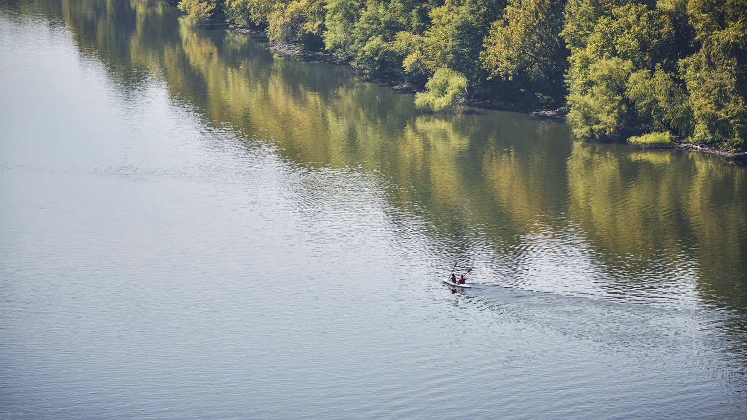Looking down at two people in kayak on Lady Bird Lake