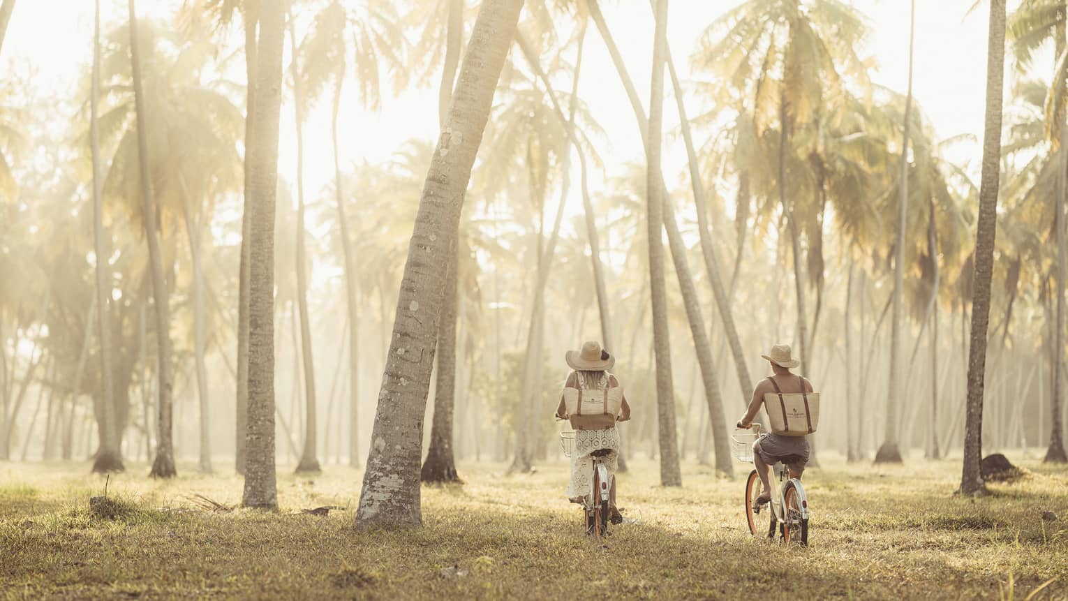 Two people on bicycles explore nature trails on a private island in the Western Indian Ocean