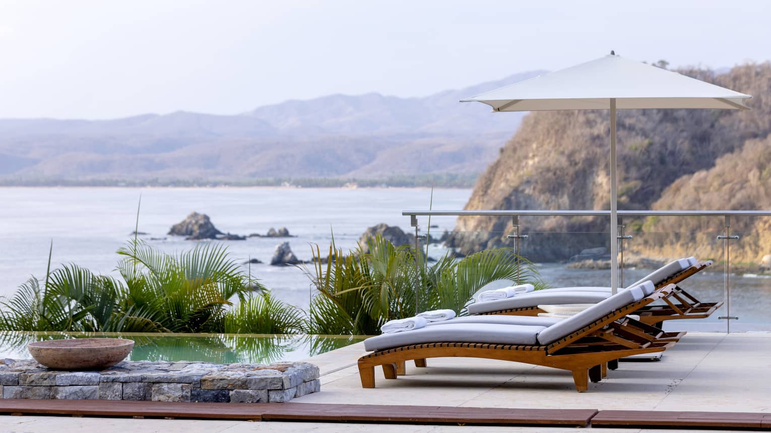 Deck chairs and ocean/beach view in background