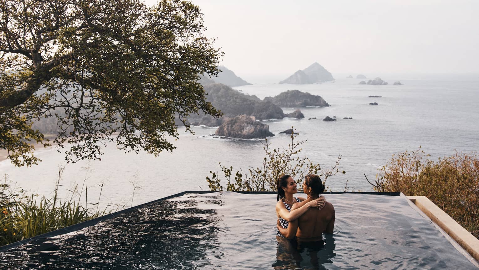 Man and woman in the outdoor infinity pool