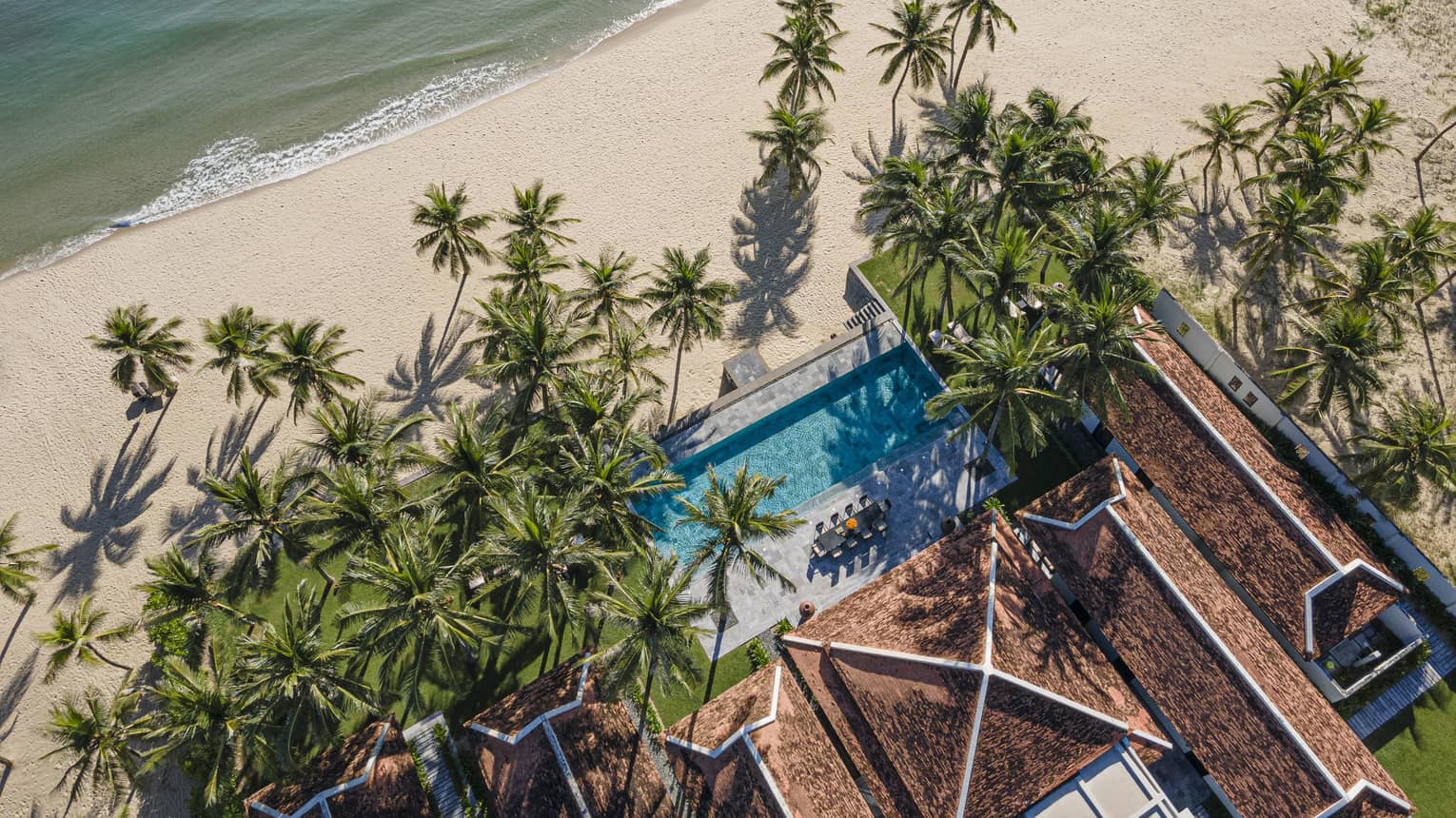 5 Bedroom Beachfront Pool Villa aerial shot with palm trees and ocean views
