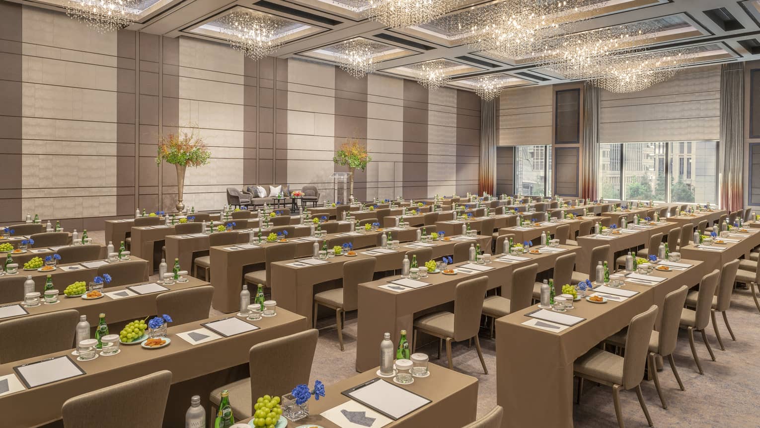 Ballroom set classroom style with gold accents and high ceilings