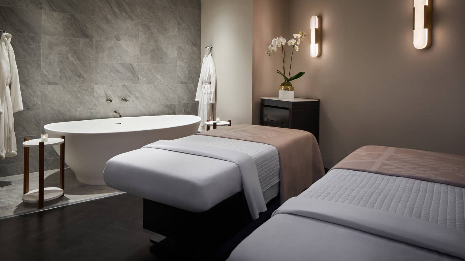 Spa room with massage tables and spa tub.