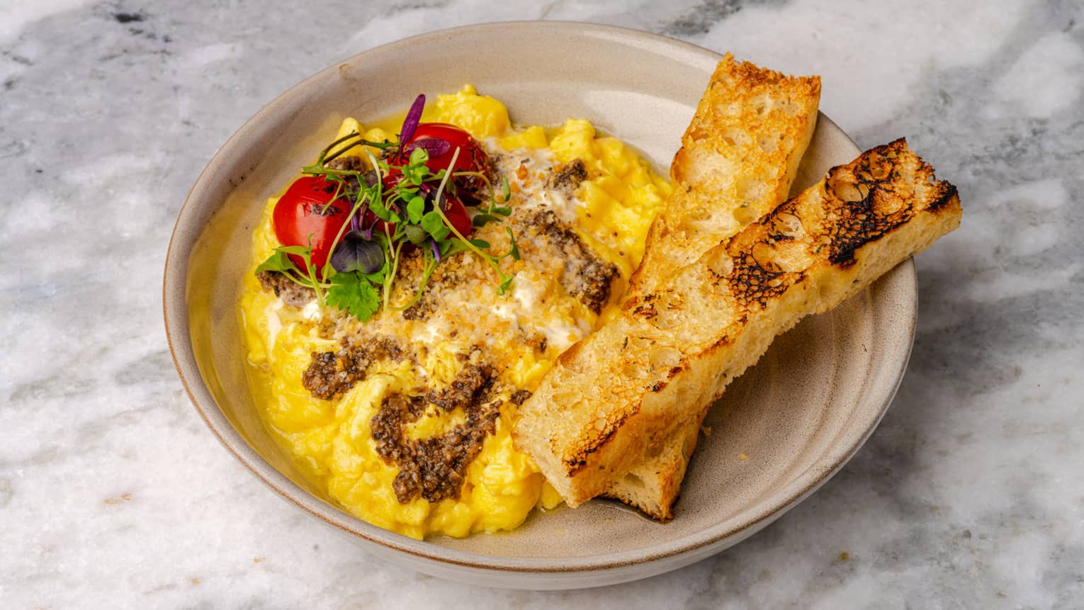 A breakfast dish with scrambled eggs and toast