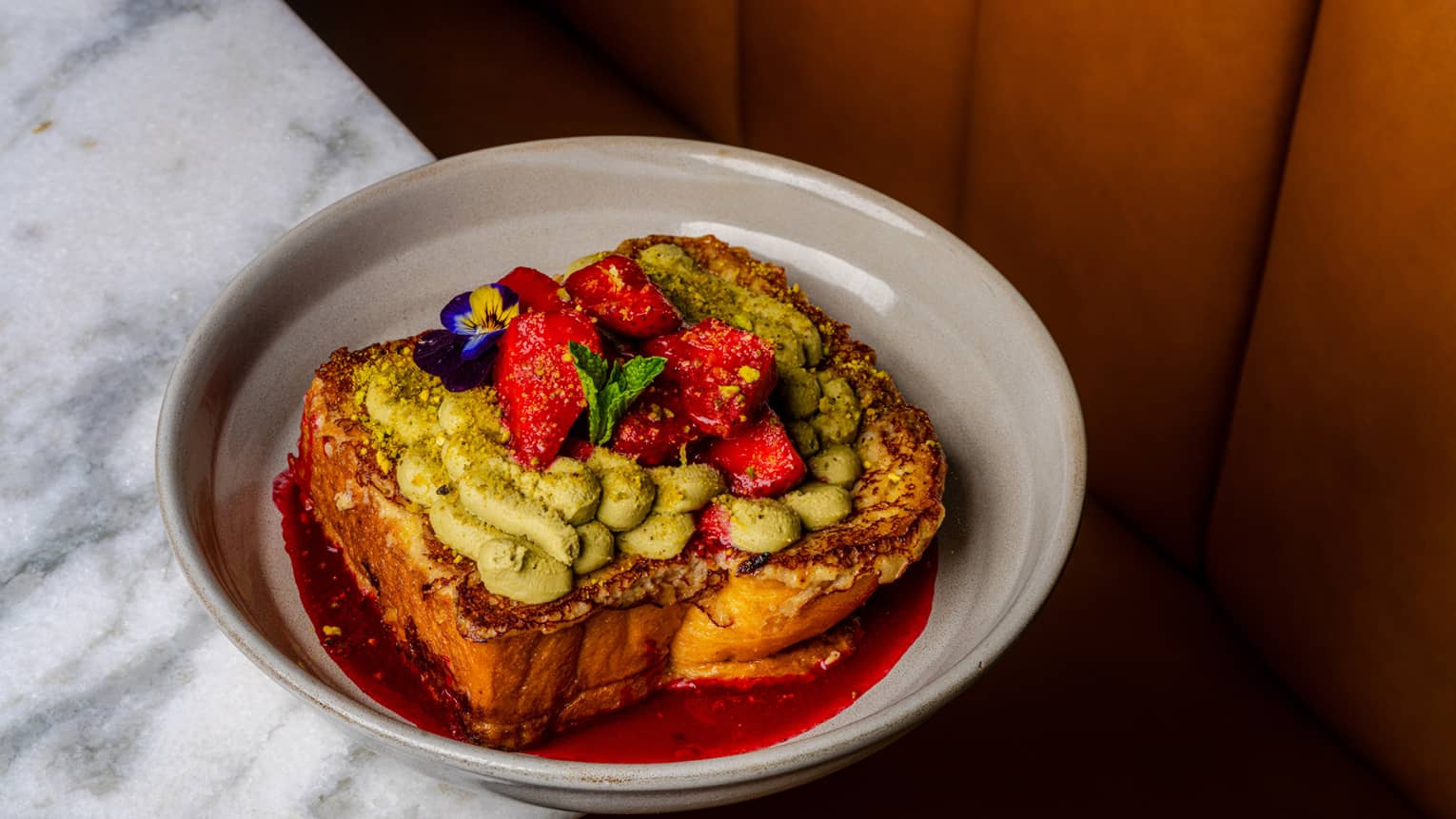 Avocado toast with sliced strawberries on top