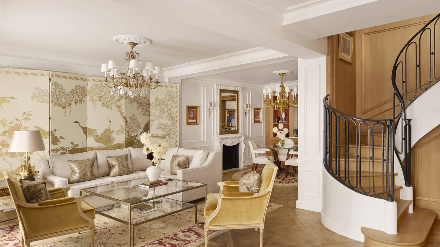 Opulent living room with curved staircase leading to upstairs