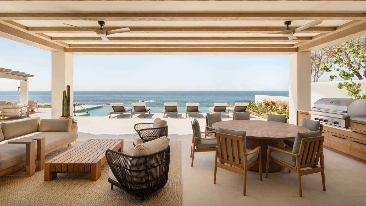 Luxury oceanfront suite terrace with dining, lounge and pool furniture, at Four Seasons Resort Cabo San Lucas at Cabo Del Sol