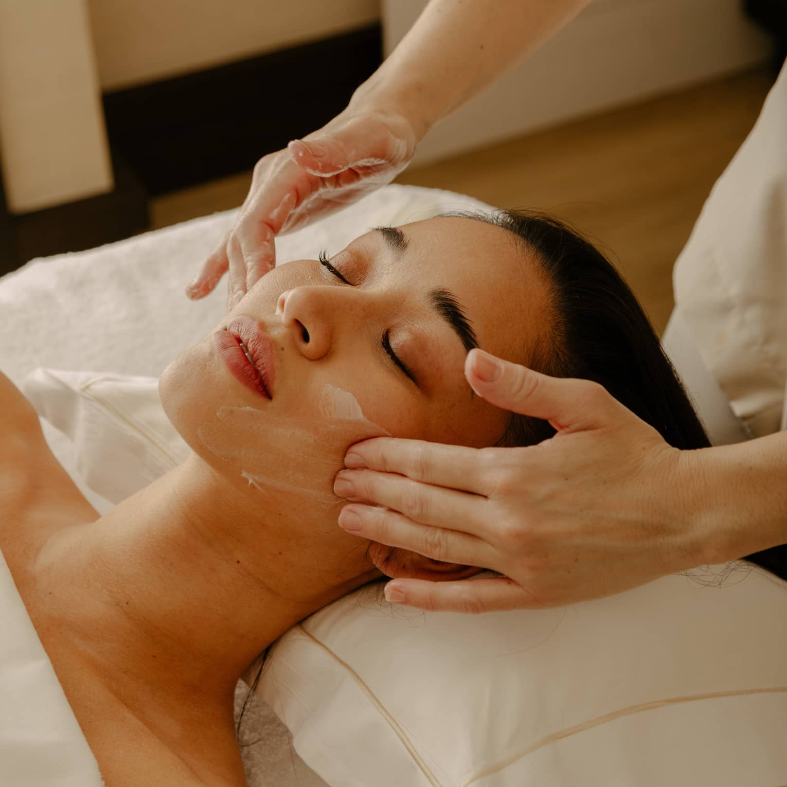 Close up of woman's face getting a facial