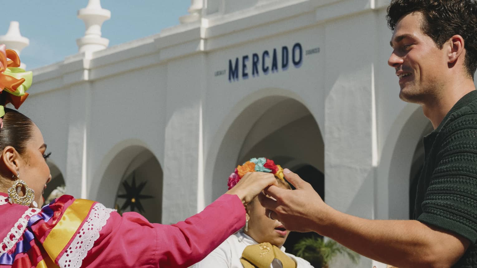 Man and woman dance in front of mariachi band