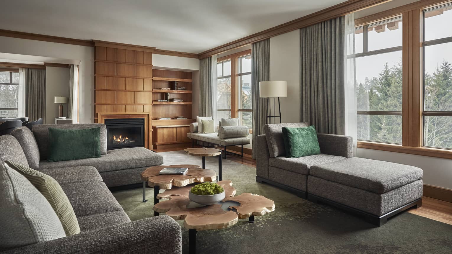 Living room of a Panorama Suite, with a large grey sofa and matching chaise lounge
