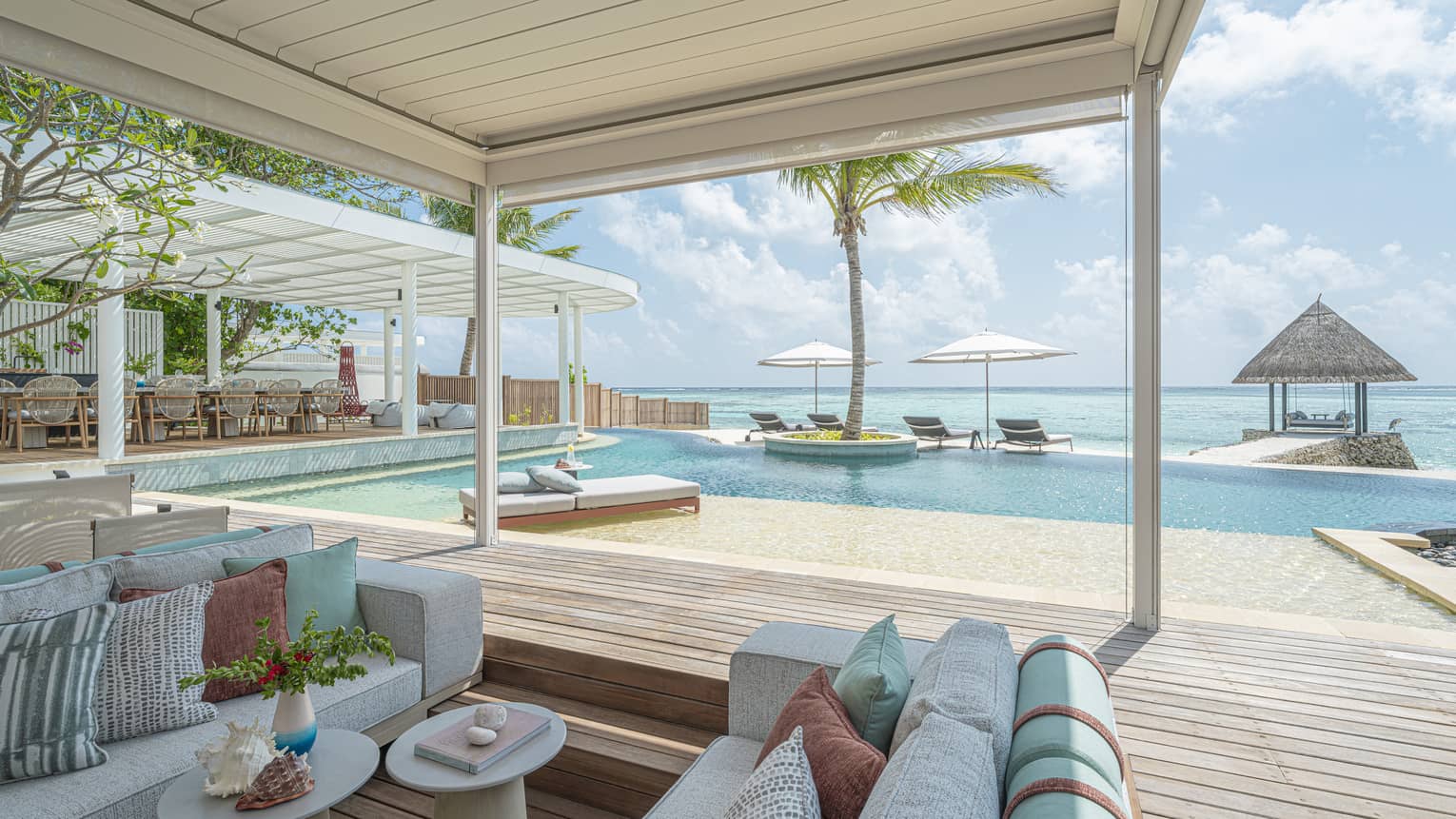 Pool terrace and covered lounge area of luxury villa in Maldives