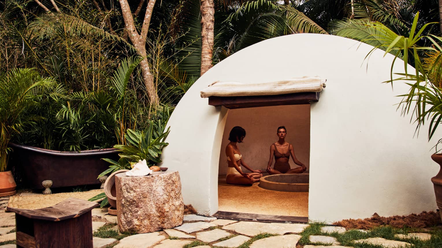 A heated dome shaped room surrounded by trees.