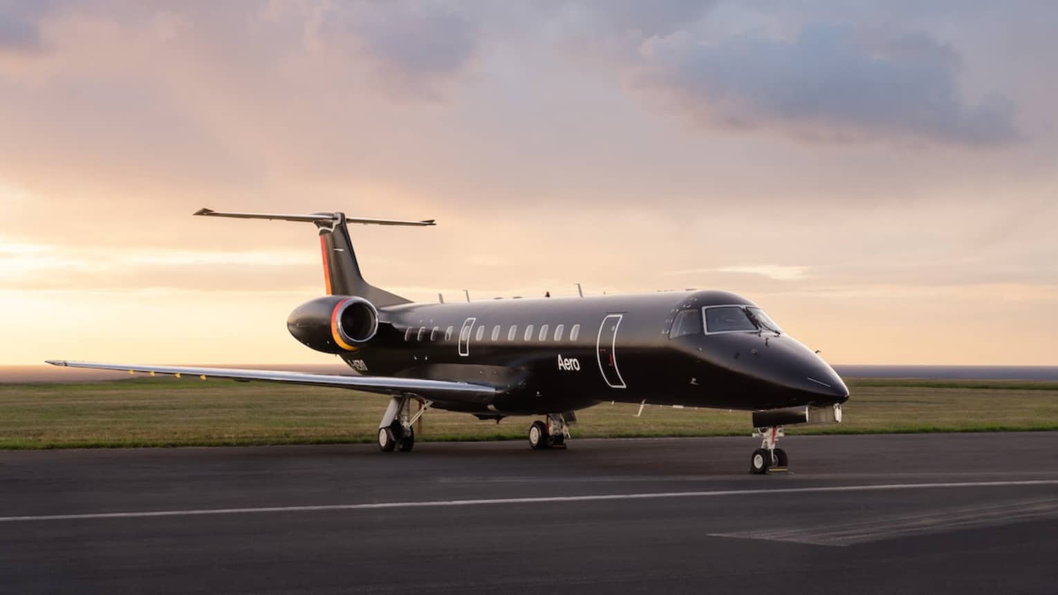 A black private jet on a runway