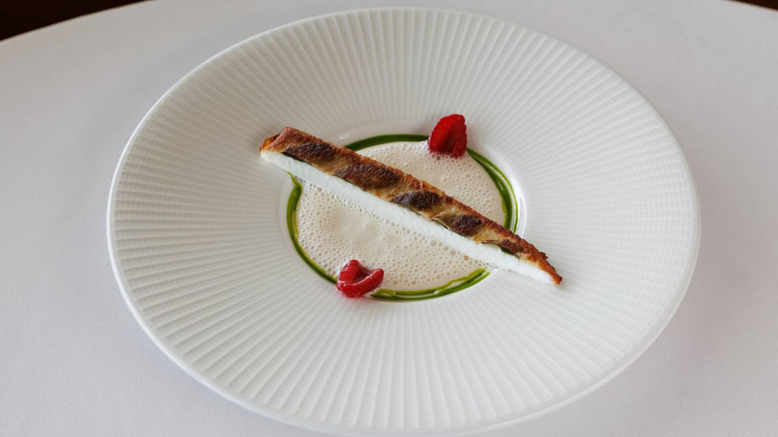 Sole with Sage, Padr�n Pepper, Raspberry Champagne Sauce in white bowl on white table