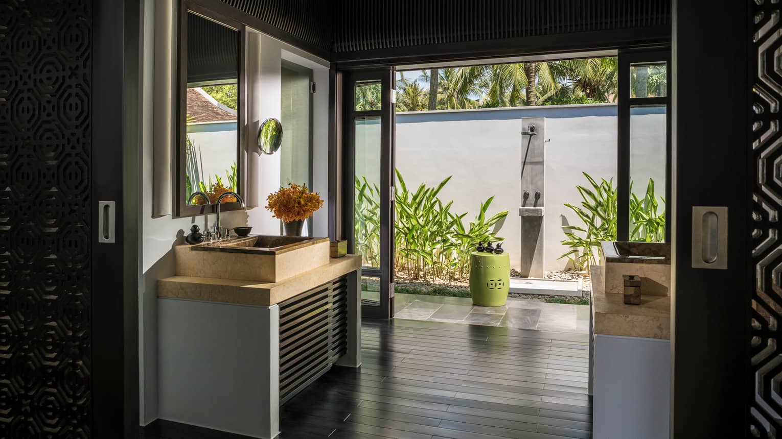 Sink, vanity in large bathroom with open wall to al fresco shower