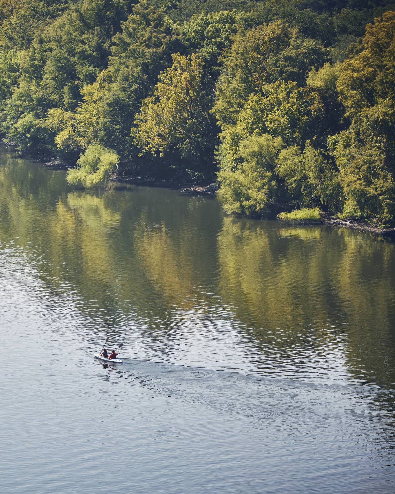 Looking down at two people in kayak on Lady Bird Lake