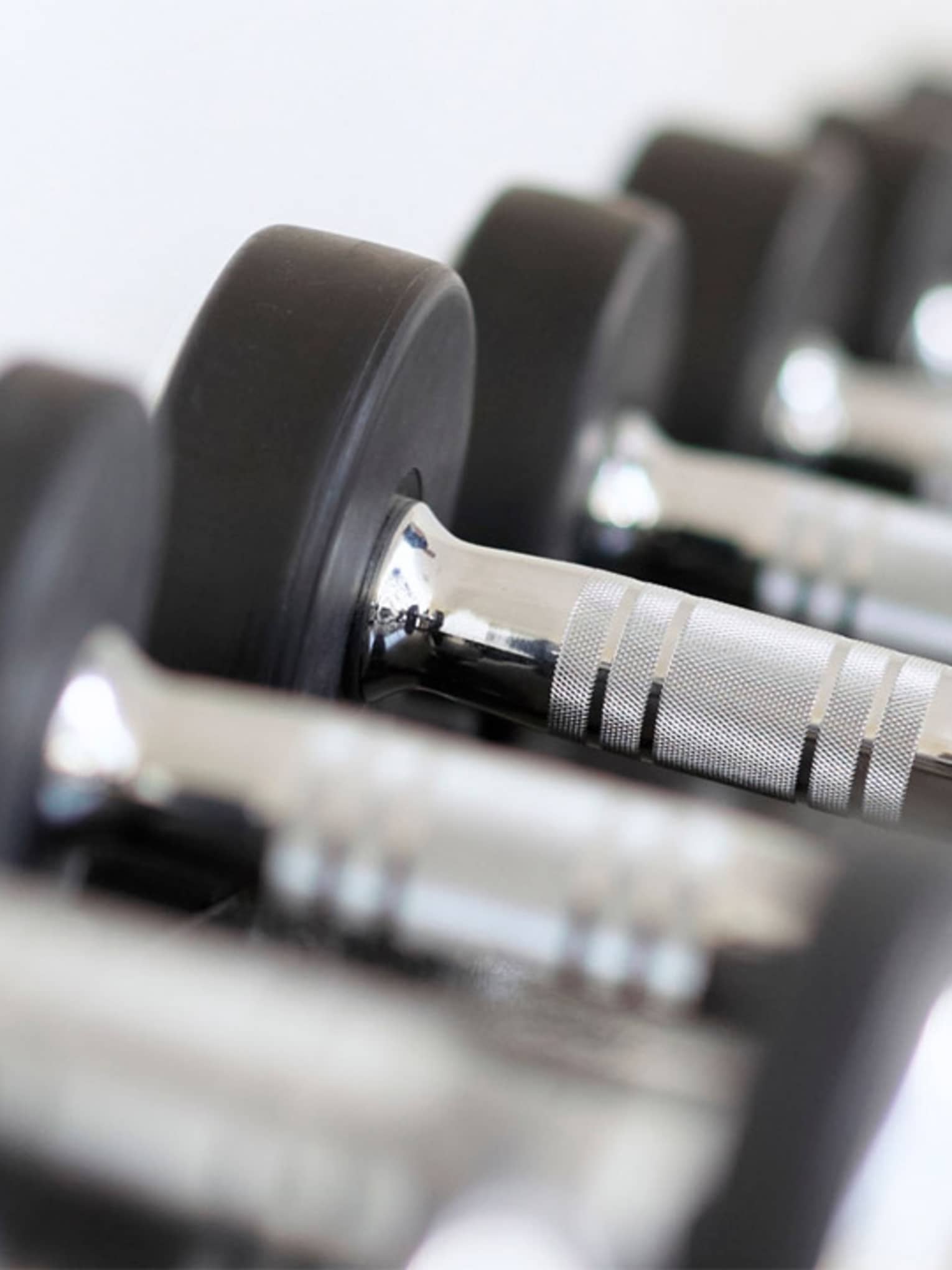 Close-up of hand weights in row on rack in Fitness Centre