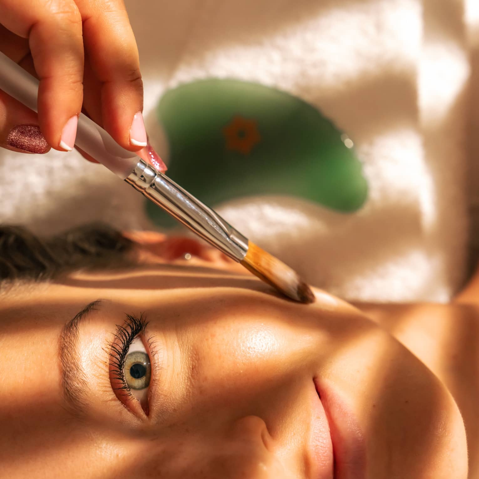 Close up of person's face being brushed