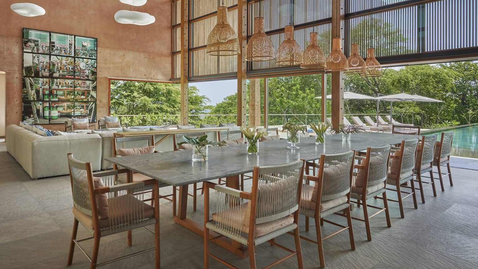 Great room with extra-high ceiling and large dining table, 12 chairs, whicker lighting fixture