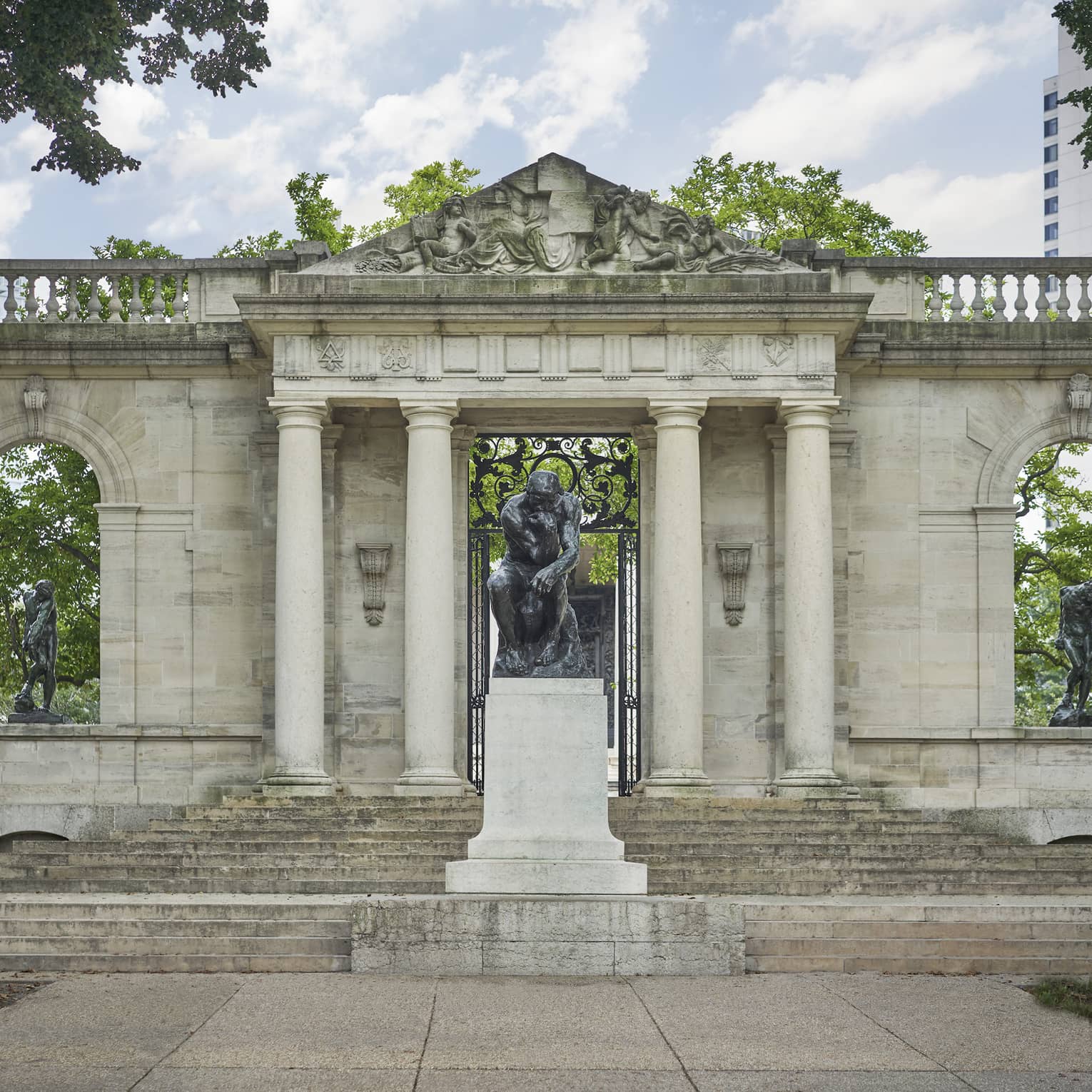 Historic stone structure with sculptures in garden