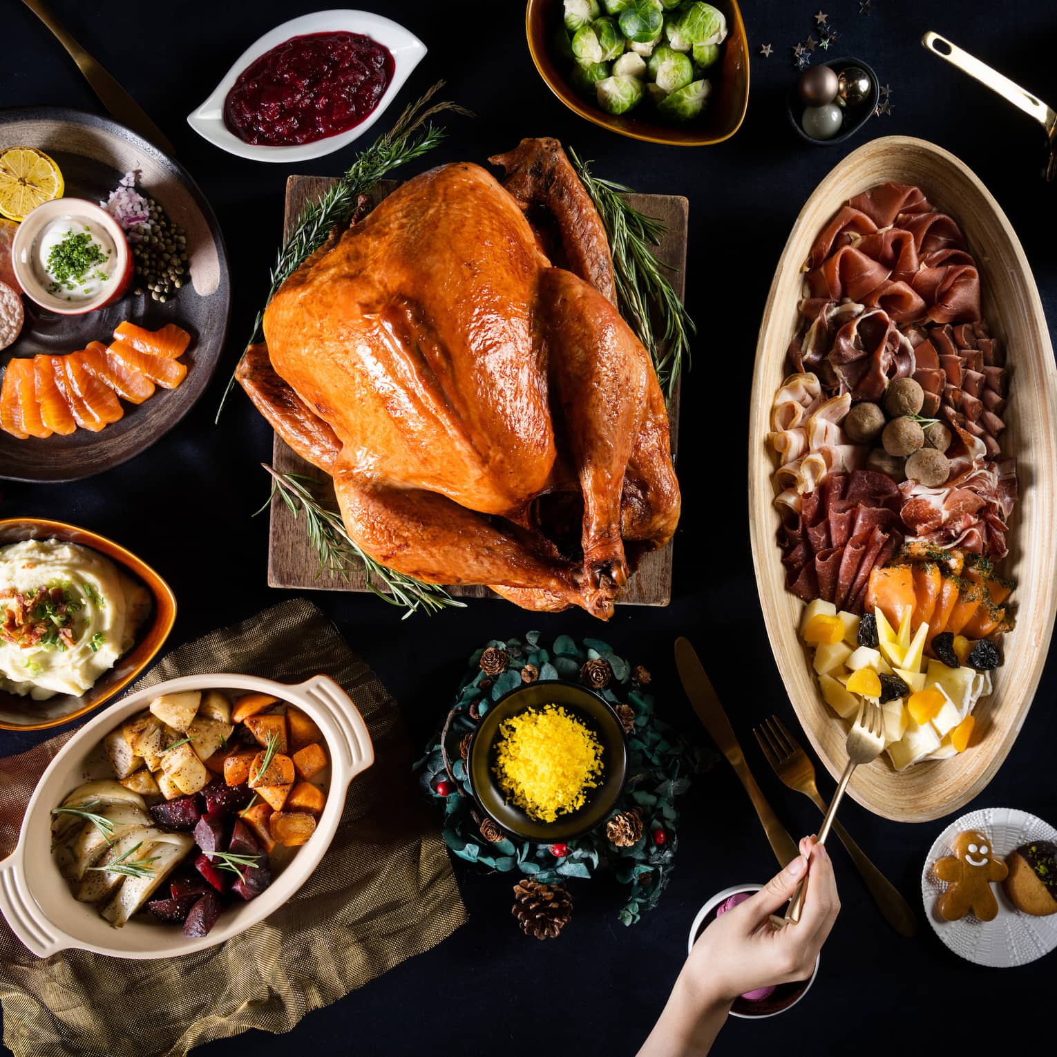 Aerial view of table with roasted turkey and various side dishes