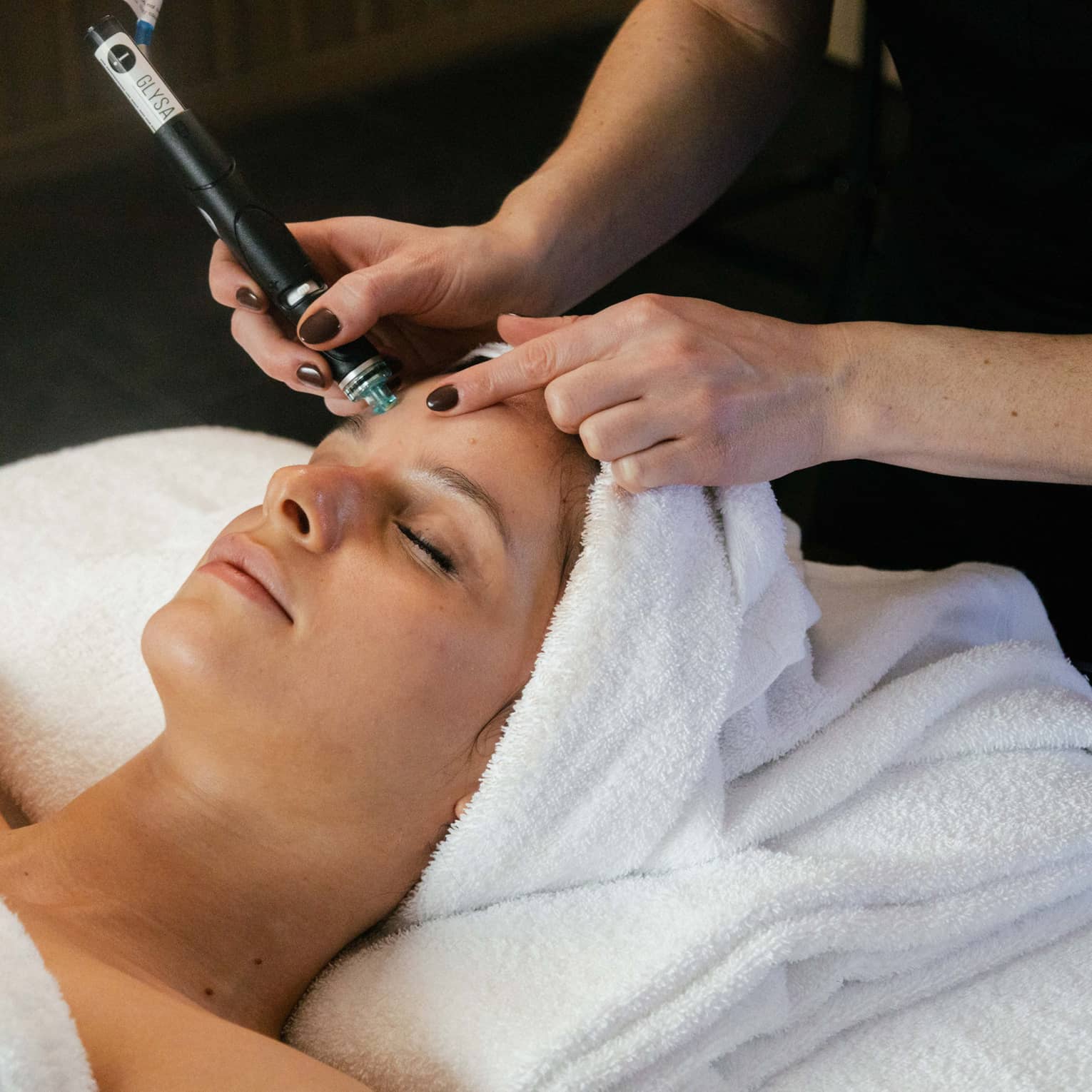 Woman on spa treatment table gets a Hydrafacial