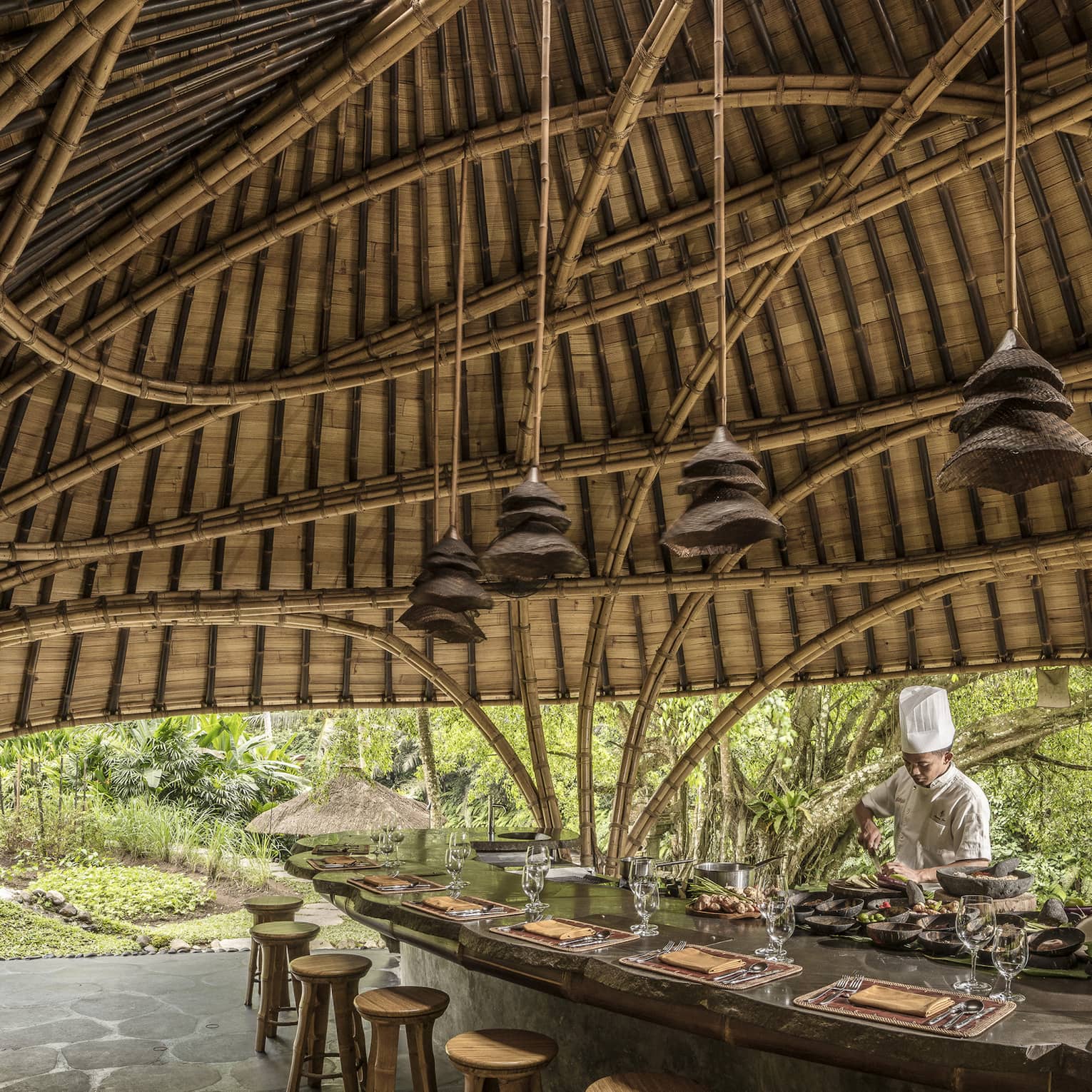 A chef prepares for Sokasi Cooking School in a bamboo pavillion