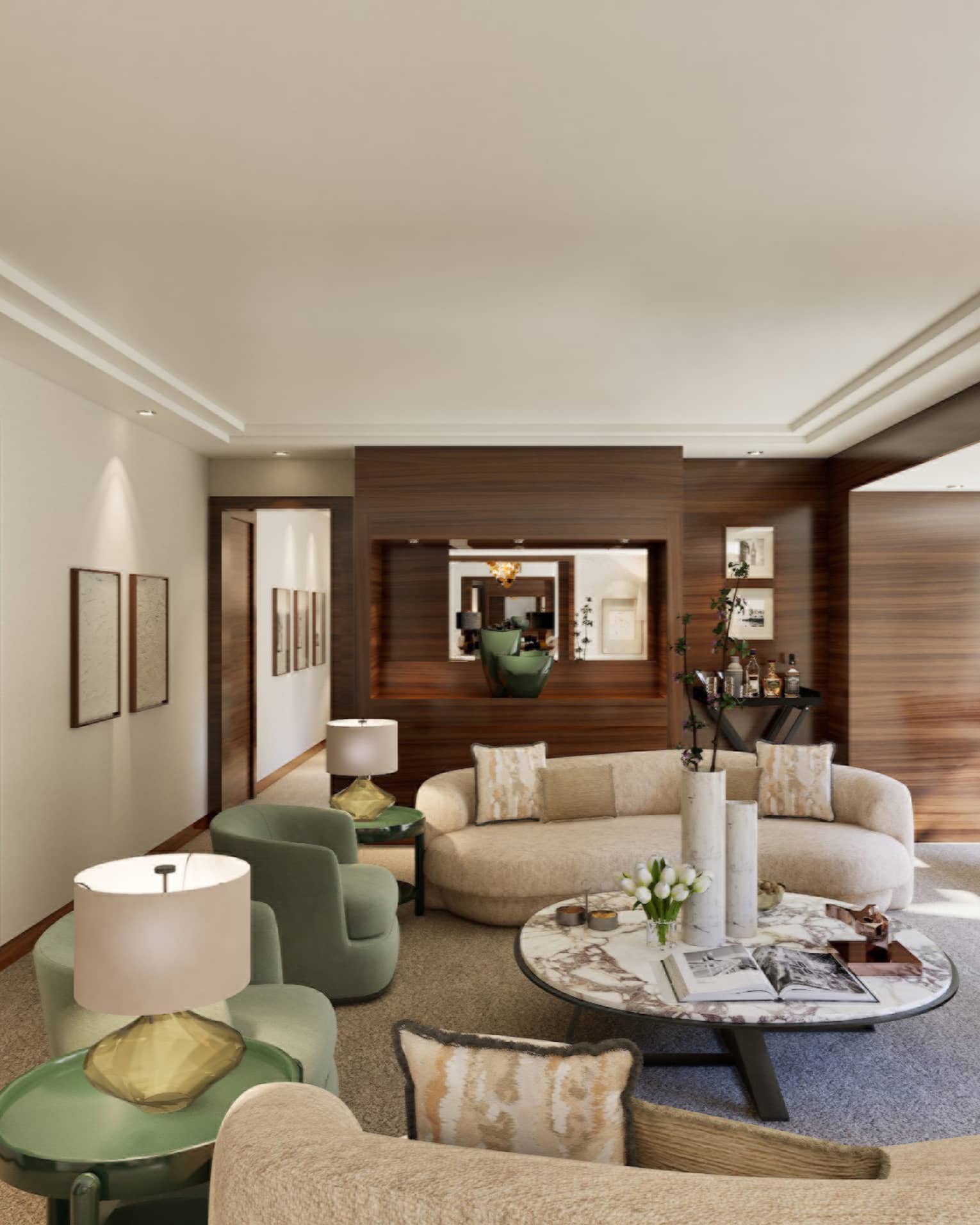 Luxury hotel suite living room featuring a cream-coloured curved sofa, large round coffee table, fireplace and TV