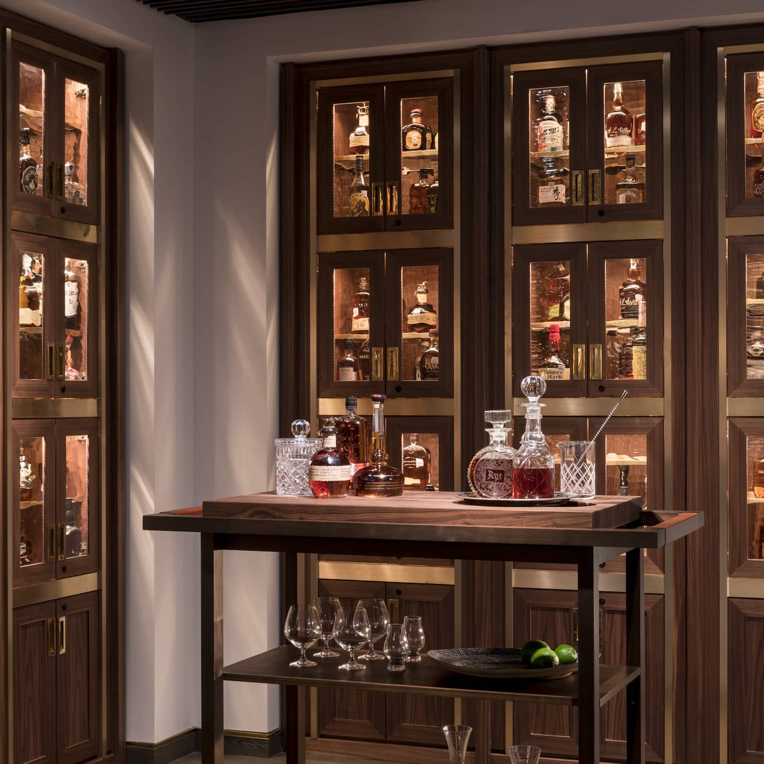 Various whiskey, bourbon, crystal bottles on bar